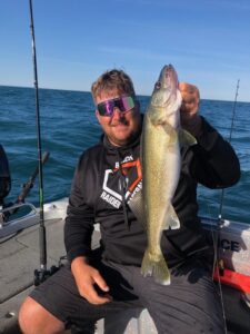 man holding fish on boat