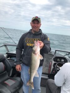 man holding a fish on a boat