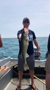 man holding a fish on a boat