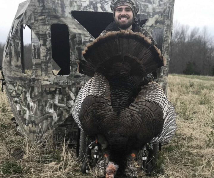 hunter holding large turkey