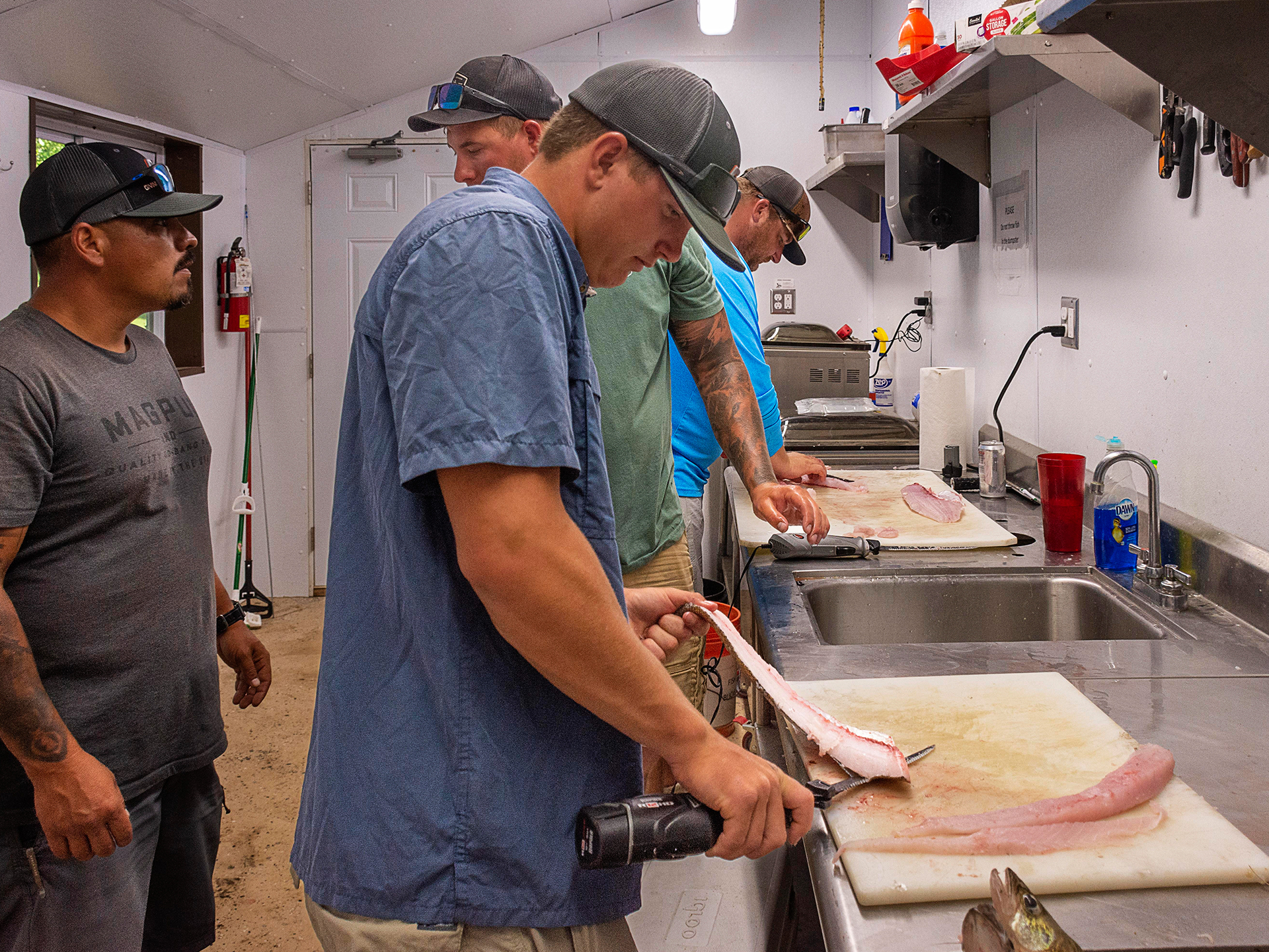 men cleaning fish