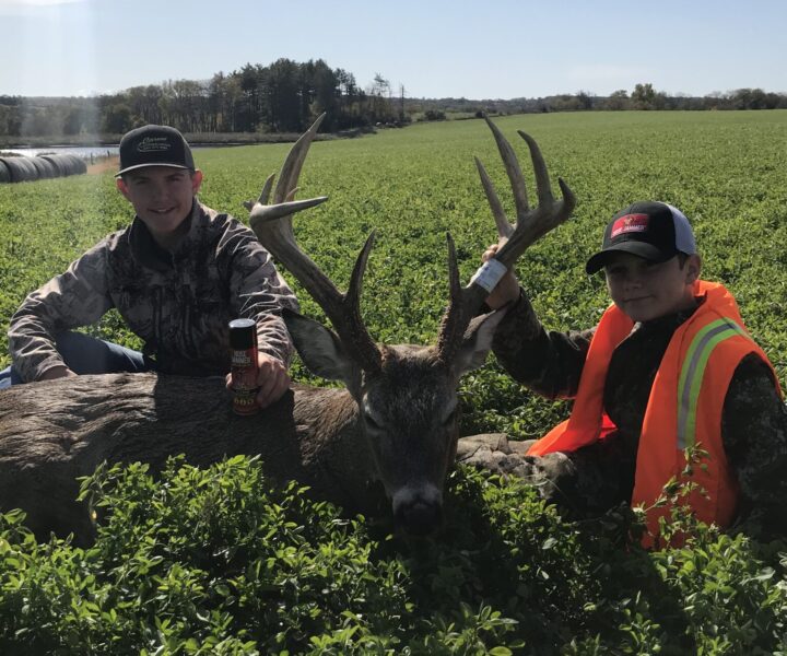 two young hunters with large deer